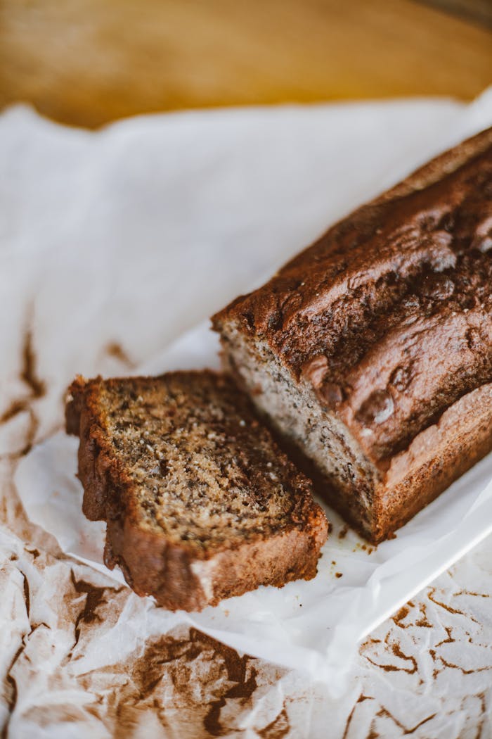 Freshly baked homemade banana bread sliced on parchment paper.